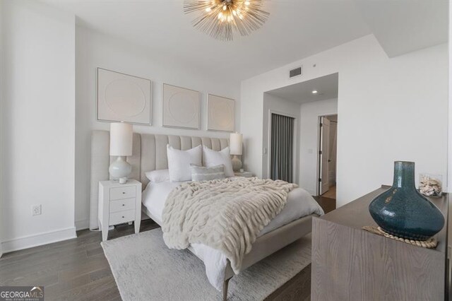 bedroom with dark wood-type flooring