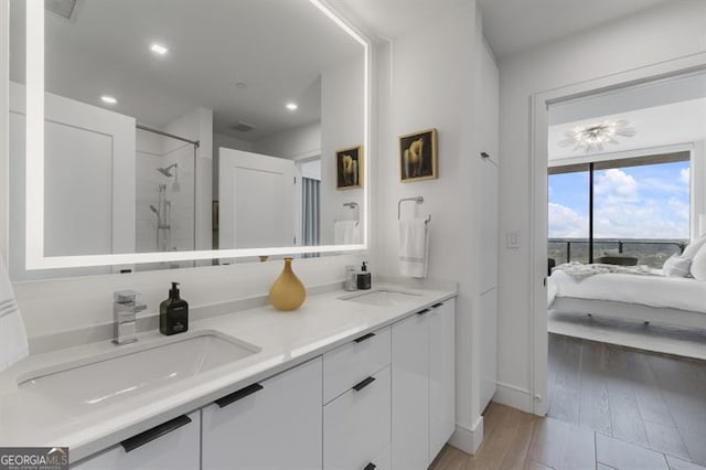 bathroom with vanity, wood-type flooring, and an enclosed shower