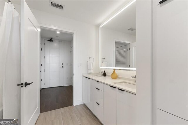 bathroom featuring vanity, hardwood / wood-style flooring, and a shower with shower curtain