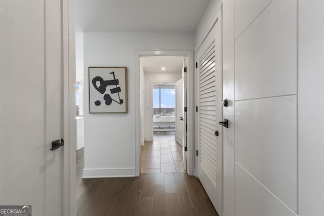 corridor with dark hardwood / wood-style floors