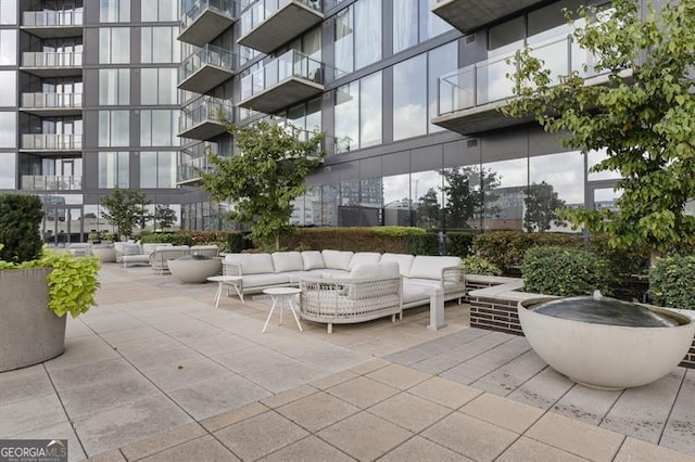 view of property's community featuring a patio and an outdoor living space