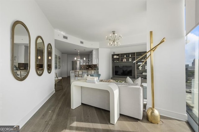 living room with hardwood / wood-style floors and a notable chandelier