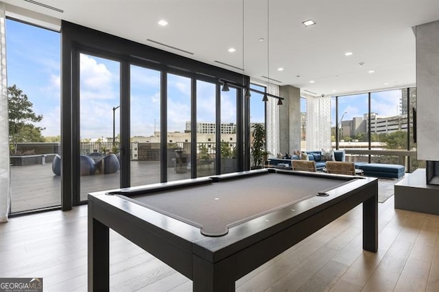 game room with light hardwood / wood-style flooring, billiards, and floor to ceiling windows