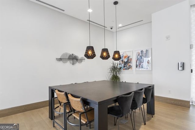 dining space with light hardwood / wood-style flooring