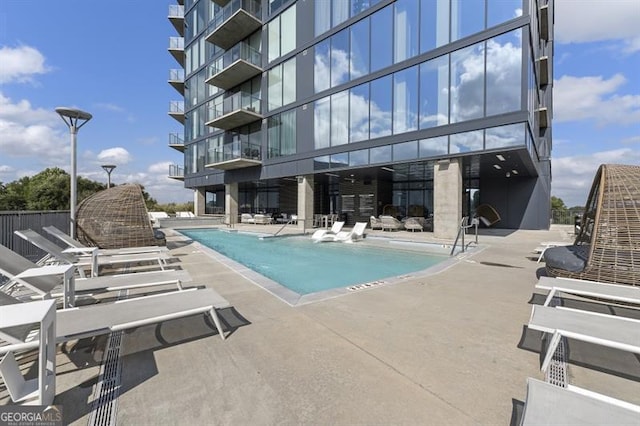 view of swimming pool featuring a patio area