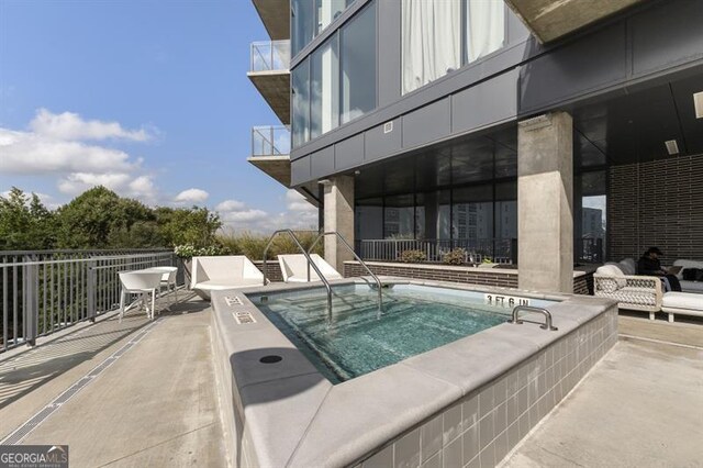 view of pool with a community hot tub