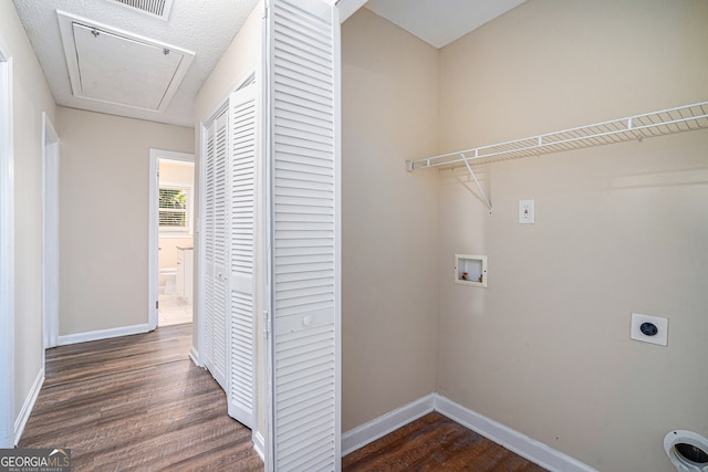 washroom with hookup for a washing machine, dark hardwood / wood-style floors, and electric dryer hookup