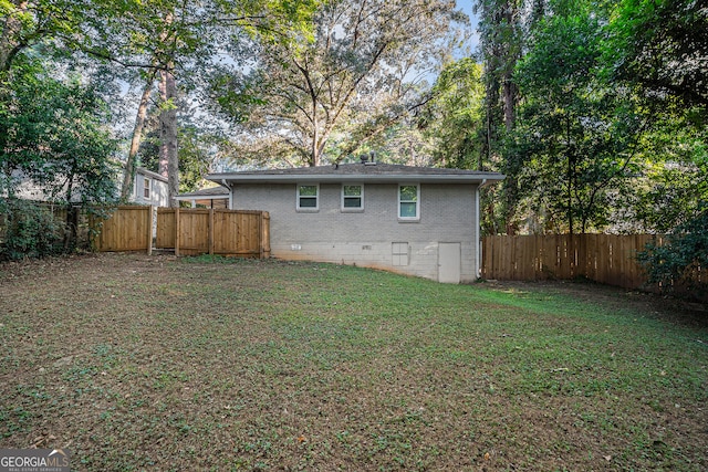 rear view of house with a yard