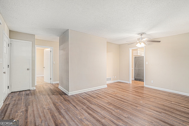 unfurnished room with a textured ceiling, hardwood / wood-style floors, and ceiling fan