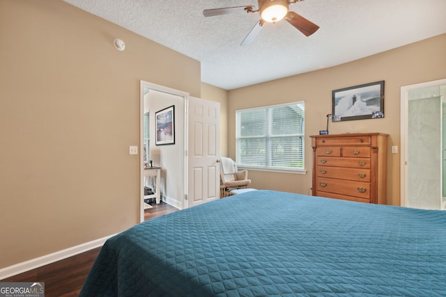 bedroom featuring a textured ceiling, dark wood-type flooring, and ceiling fan