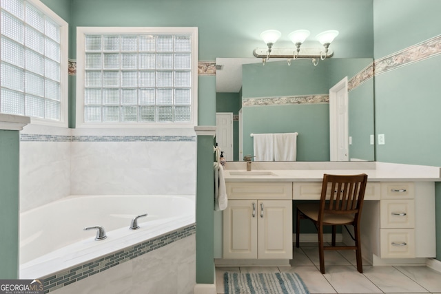 bathroom with vanity, tile patterned flooring, and a relaxing tiled tub