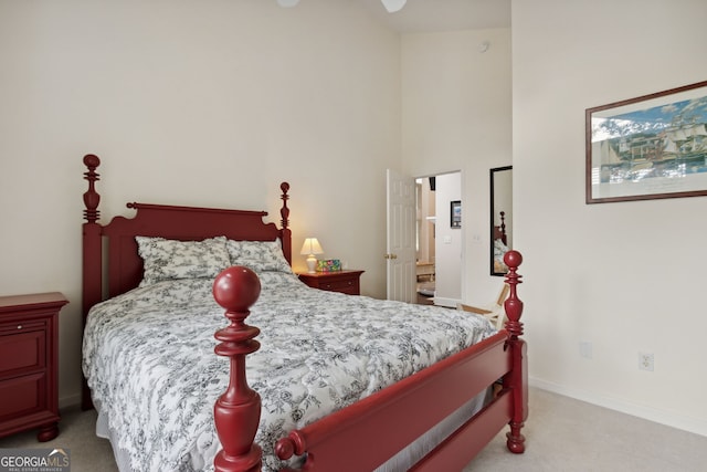 carpeted bedroom featuring a towering ceiling