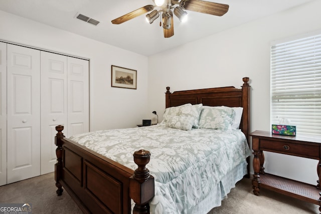 carpeted bedroom featuring a closet and ceiling fan