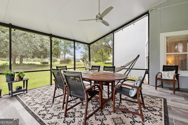 sunroom with lofted ceiling and ceiling fan