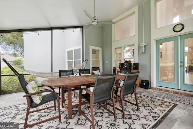 interior space with ceiling fan, french doors, and a high ceiling