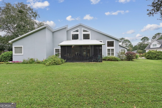 back of property with a sunroom and a yard