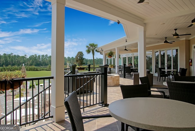 view of patio with an outdoor living space and ceiling fan