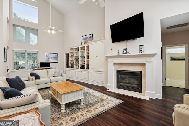 living room with ceiling fan, dark wood-type flooring, and a healthy amount of sunlight