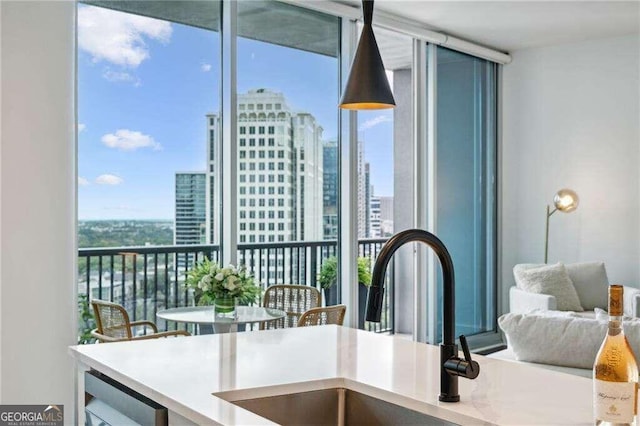 interior space featuring beverage cooler, floor to ceiling windows, sink, and a wealth of natural light