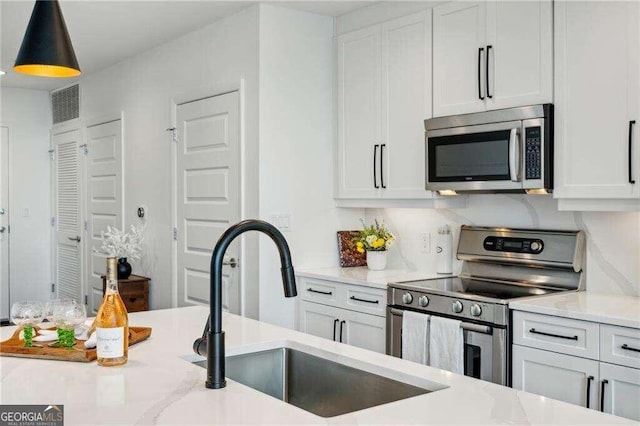 kitchen featuring white cabinets and appliances with stainless steel finishes