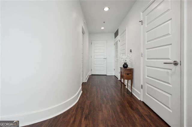 hallway with dark wood-type flooring