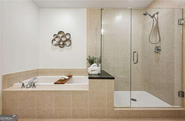 bathroom with shower with separate bathtub