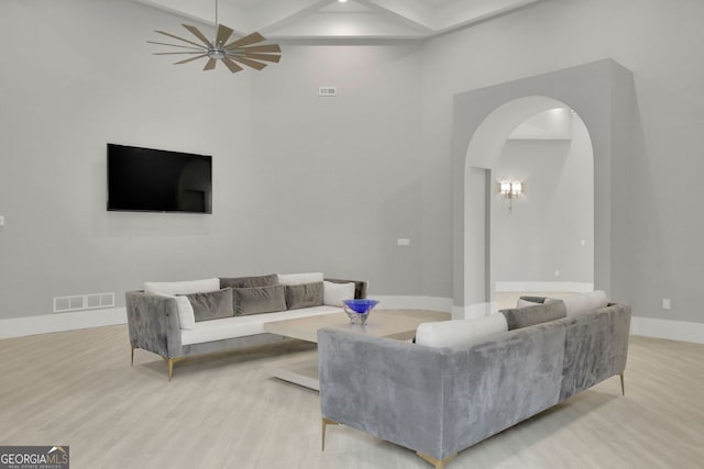 living room with ceiling fan and light wood-type flooring