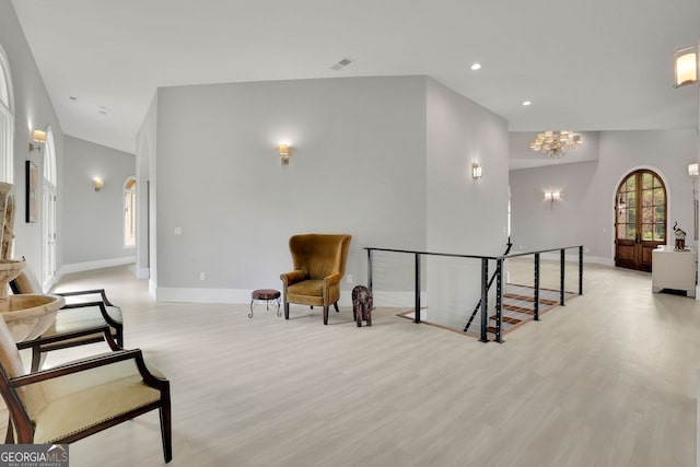 living area with a notable chandelier and light hardwood / wood-style floors