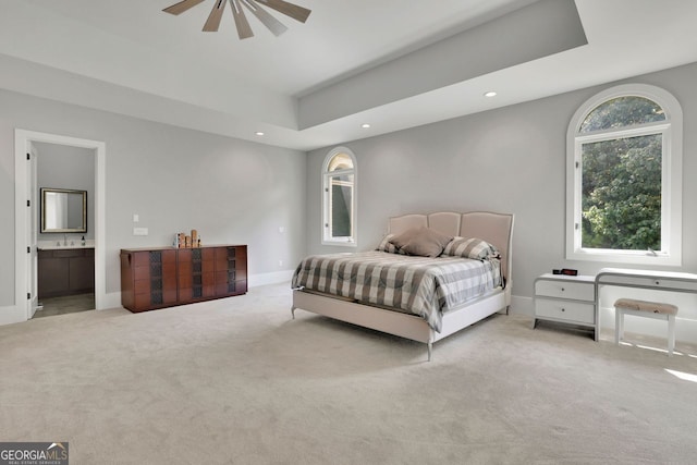 carpeted bedroom with connected bathroom and ceiling fan