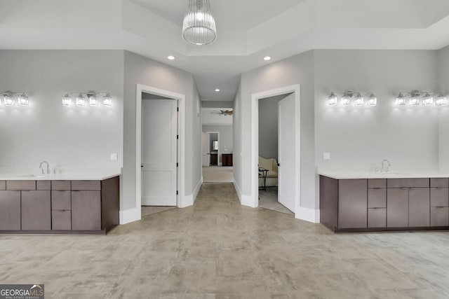 bathroom featuring vanity and ceiling fan with notable chandelier