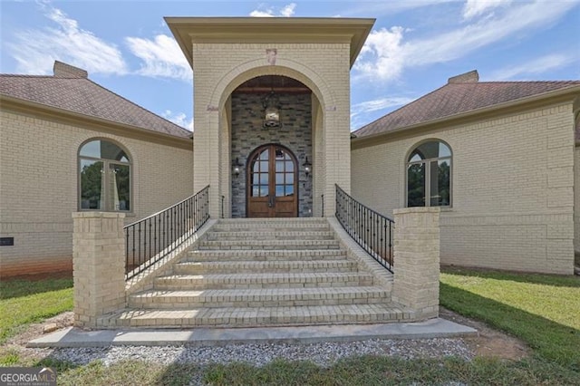 view of exterior entry featuring french doors