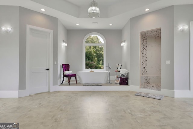 bathroom featuring an inviting chandelier and shower with separate bathtub