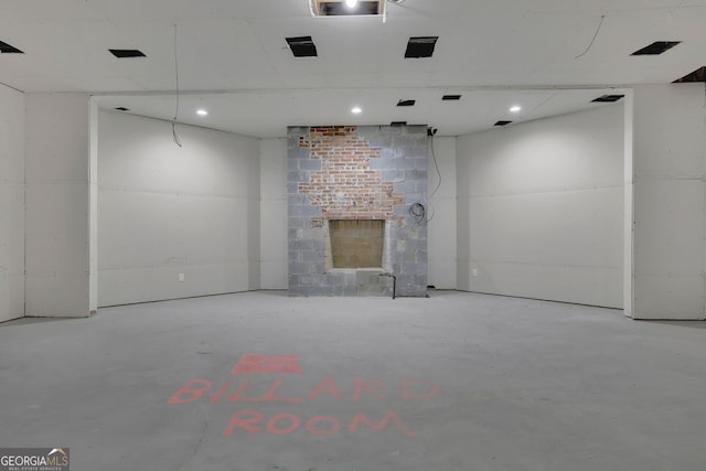 unfurnished living room featuring concrete flooring