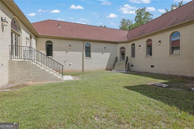 rear view of house with a lawn