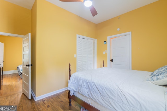 bedroom with a closet, hardwood / wood-style flooring, and ceiling fan