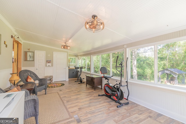 sunroom with a healthy amount of sunlight and lofted ceiling