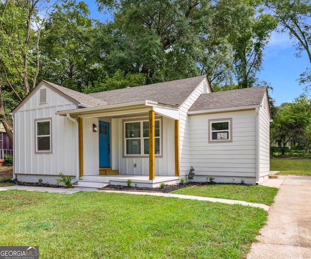 view of front of home with a front yard and covered porch