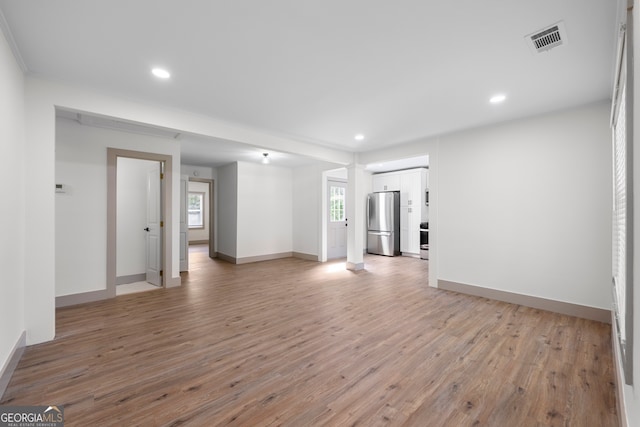 unfurnished living room with light hardwood / wood-style flooring