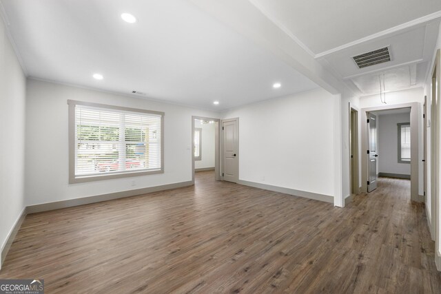 empty room featuring dark hardwood / wood-style floors and ornamental molding