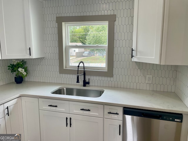 kitchen with decorative backsplash, dishwasher, sink, and white cabinets