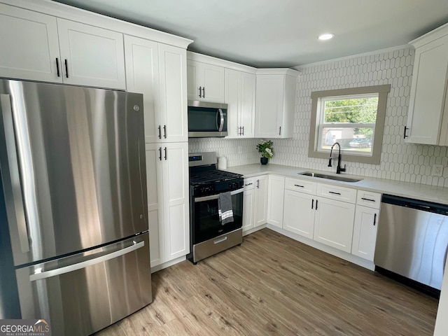 kitchen featuring white cabinets, appliances with stainless steel finishes, and sink