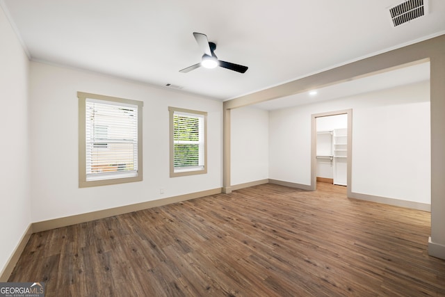 empty room with ornamental molding, ceiling fan, and hardwood / wood-style flooring