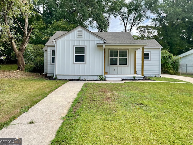 modern farmhouse with a front lawn and a porch