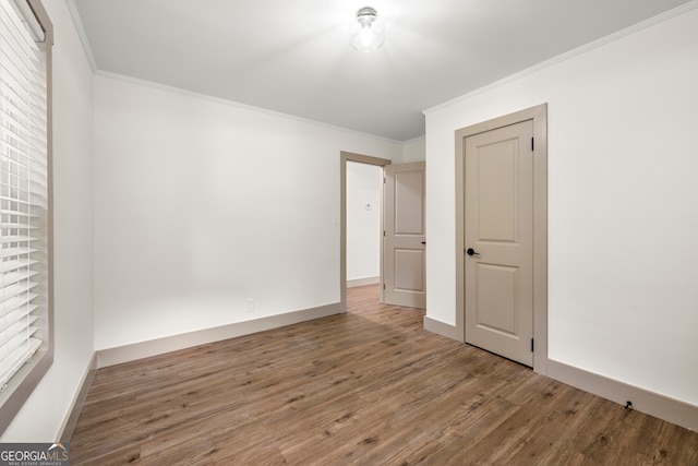 unfurnished room with wood-type flooring and crown molding