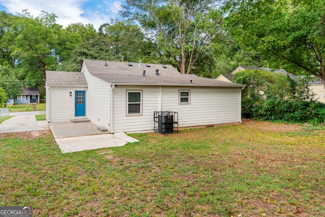 back of house featuring a patio and a yard