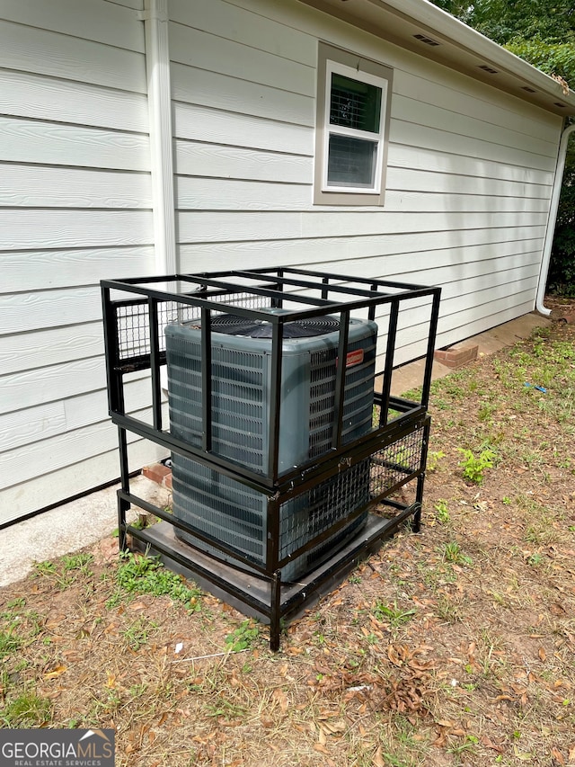 exterior details featuring cooling unit and wooden walls