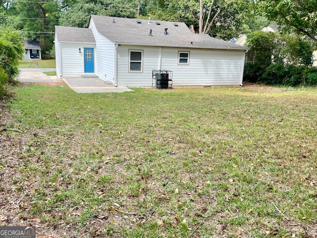 rear view of house with a lawn