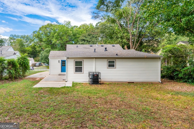 back of house with a patio and a yard