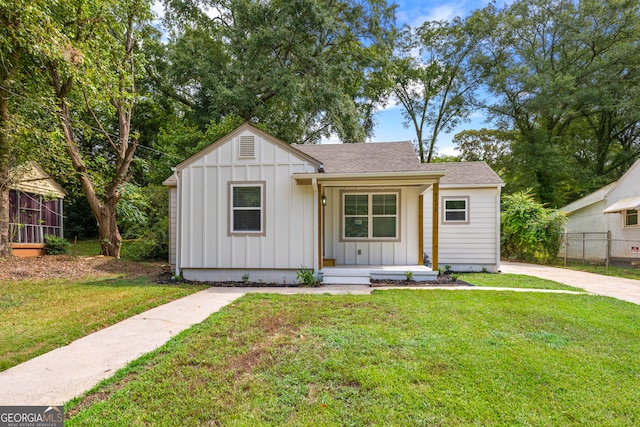 modern farmhouse style home with a front yard