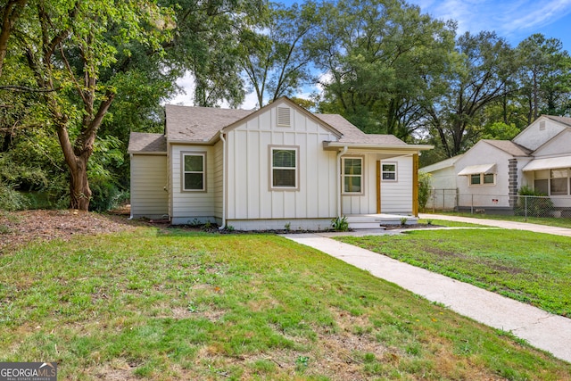 modern farmhouse style home with a front yard